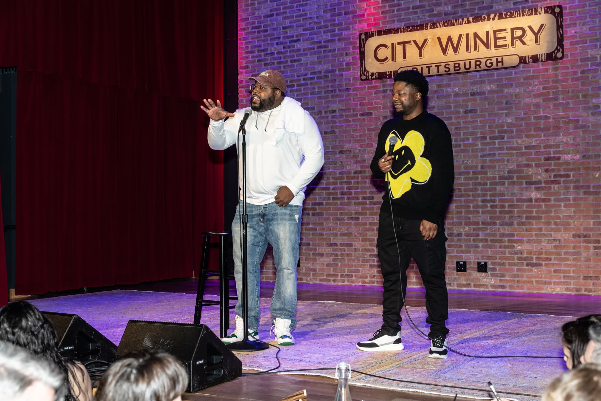 Two comedians on stage at City Winery Pittsburgh